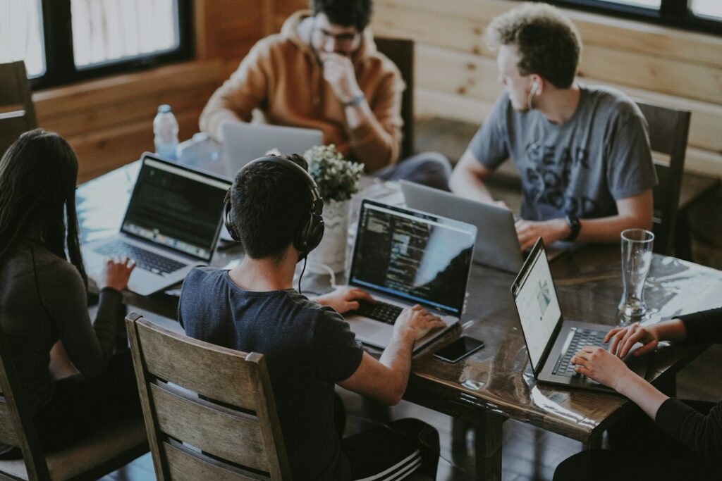 group of people using laptop computer